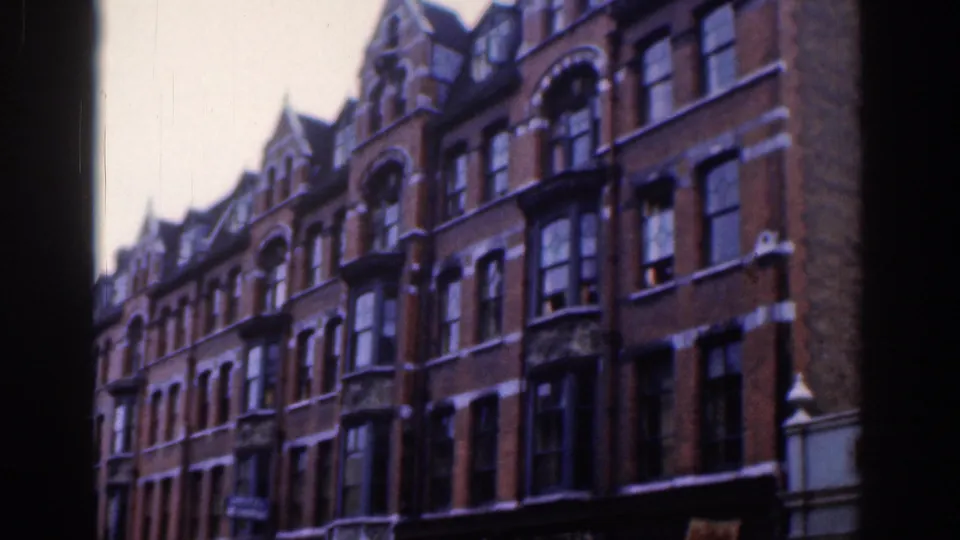 Final 1961 Dublin frame holding on red-brick townhouses, bay windows, roof peaks, and a dark vertical edge at the right.