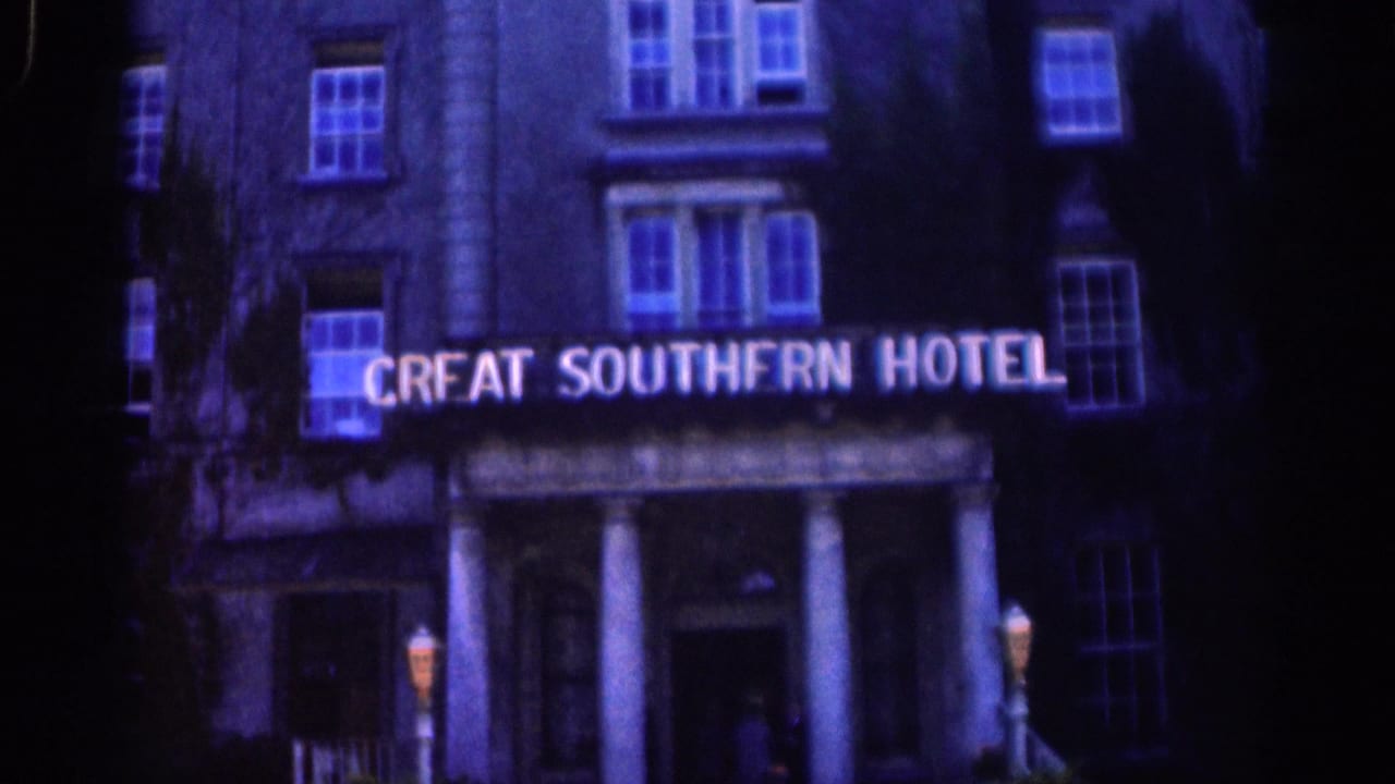 Great Southern Hotel facade in Dublin, with the sign lit above a columned entrance and upper windows visible in dark exposure.