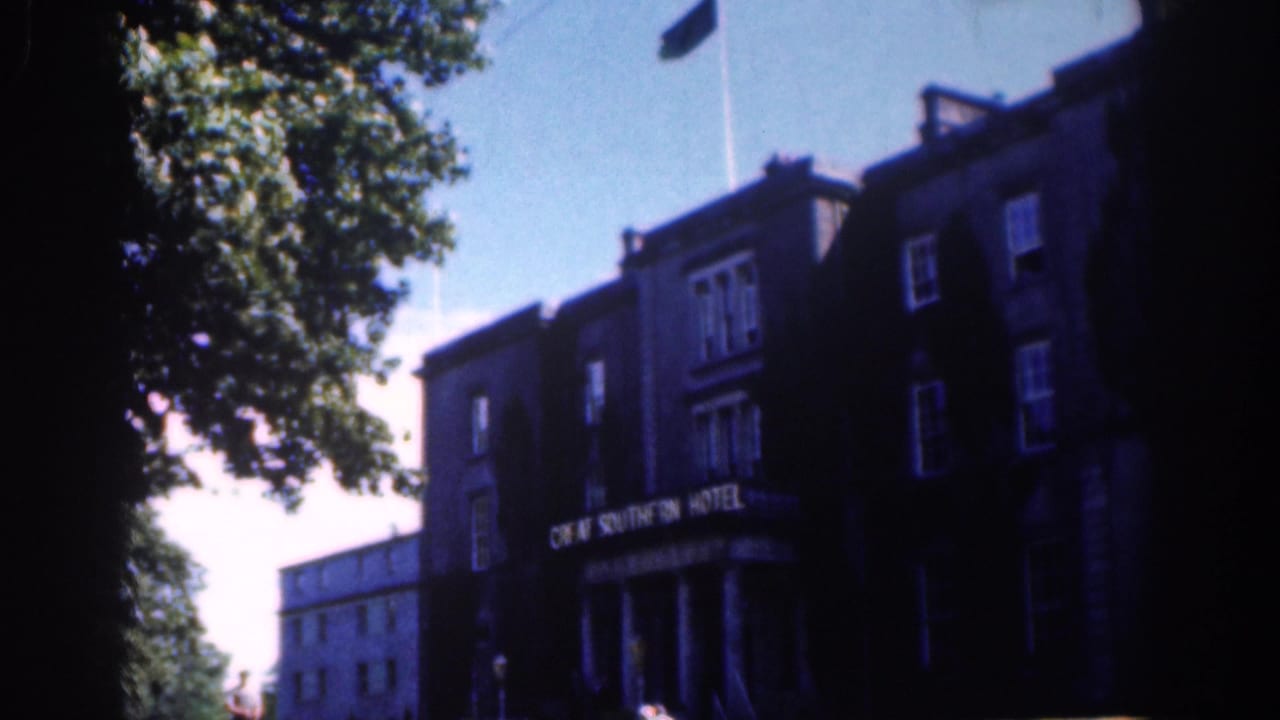 Daytime Dublin exterior of the Great Southern Hotel, with a tree at left, flagpole above and the hotel sign visible on the facade.