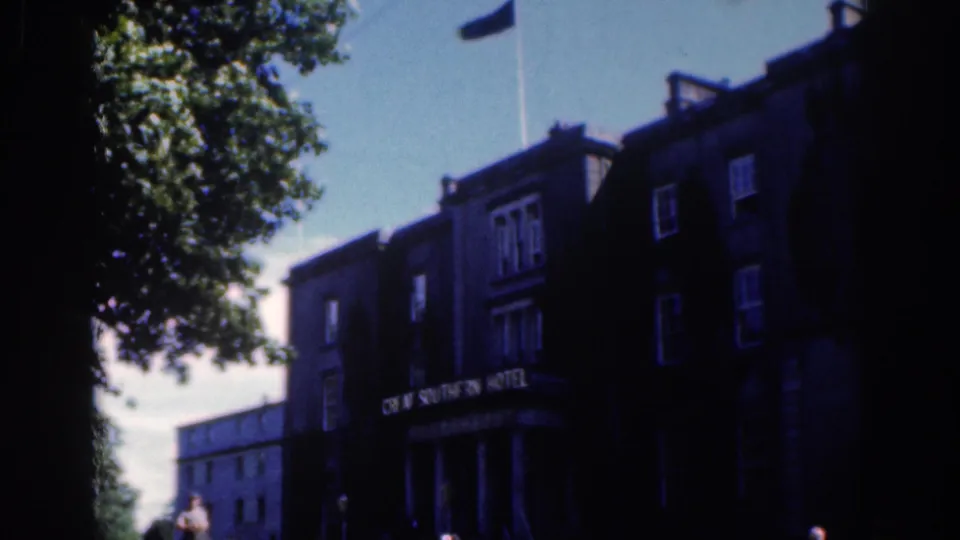 Visitor-shot view of the Great Southern Hotel in Dublin, showing the sign, entrance columns, leafy tree and small people near street level.