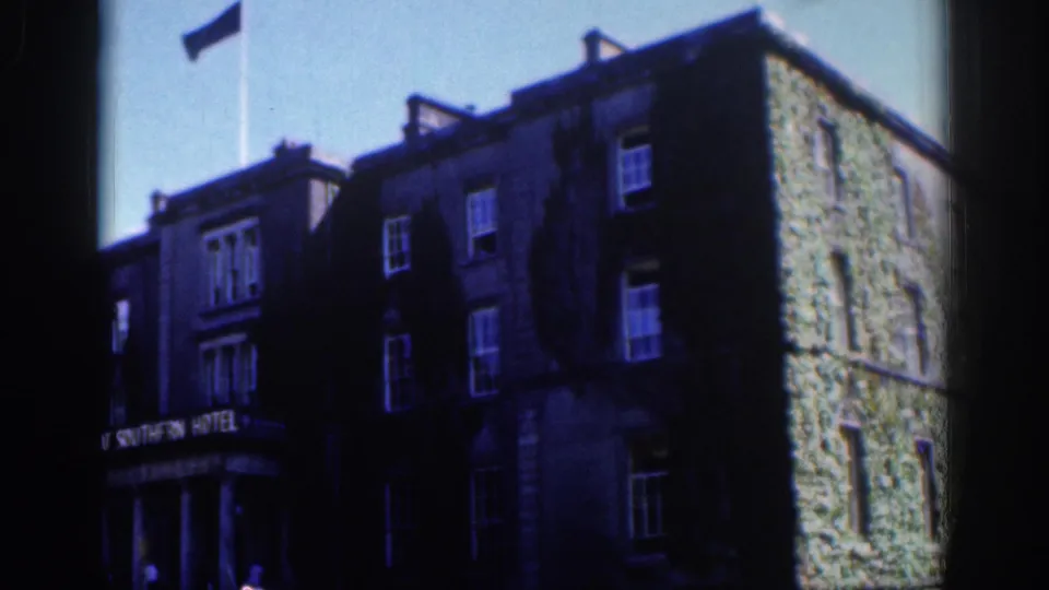 Angled Dublin view of the Great Southern Hotel, with the sign over the entrance and an ivy-covered side wall in bright daylight.