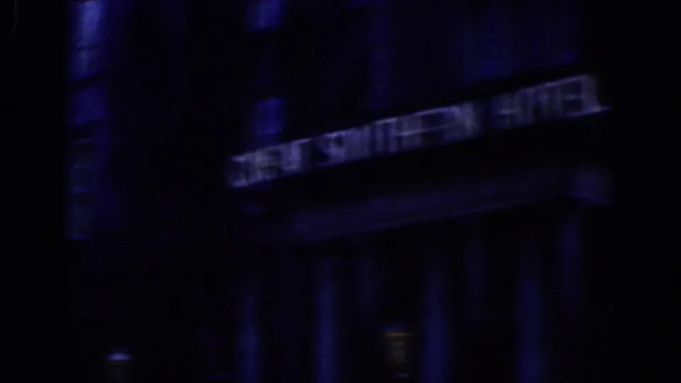 Dark 1961 Dublin frame showing the Southern Hotel sign on a building facade, with columns and shadowed street-level details below.