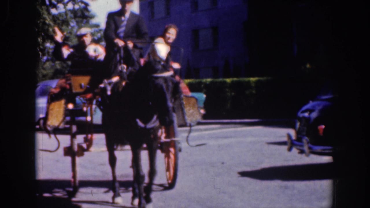 1961 Dublin frame showing a horse-drawn carriage with a suited driver and passengers on a bright city street.