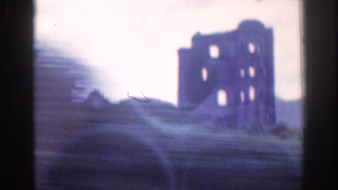 A castle-like ruin appears on a hill in the Dublin-area 1961 home movie, filmed softly from a moving viewpoint.