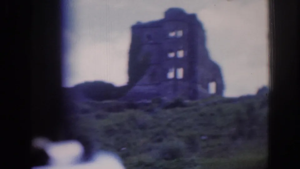 A closer moving-view shot shows the Dublin-area ruin on a grassy slope, with prominent 8mm edge shadow and soft color.