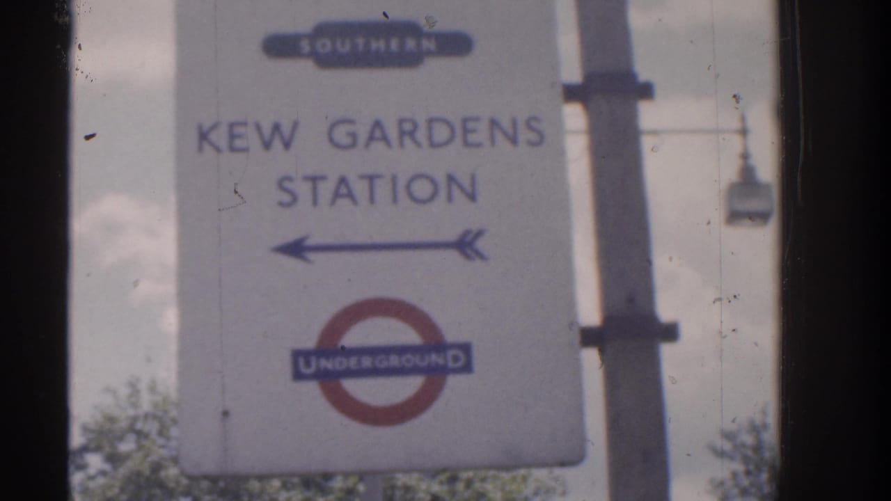 Soft 8mm frame showing a Kew Gardens Station direction sign with Southern Railway text and a London Underground roundel.