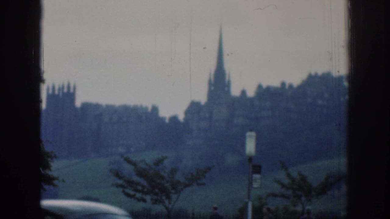 Soft distant skyline with church spire, hillside, trees and a roadside signpost.