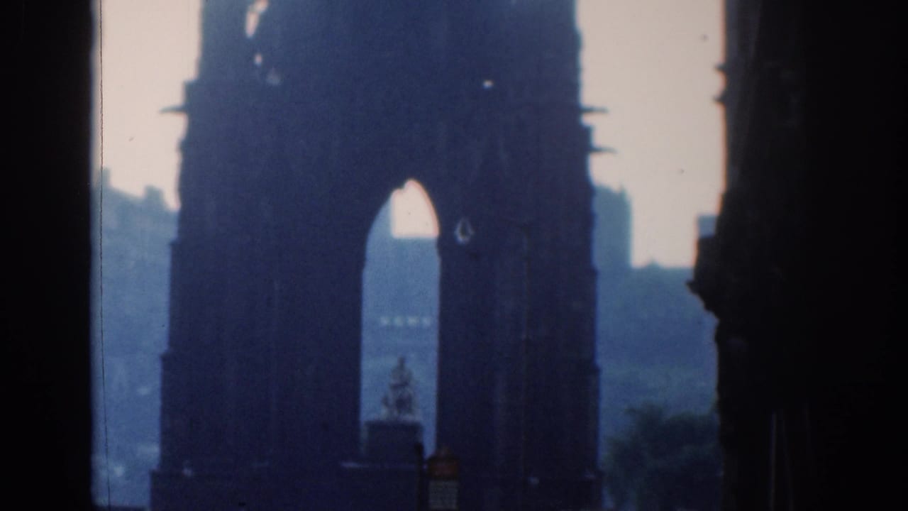 Large arch and dark column framing a distant city view.