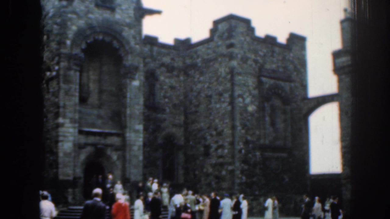 Crowd gathered outside a historic stone church with arched entrances.