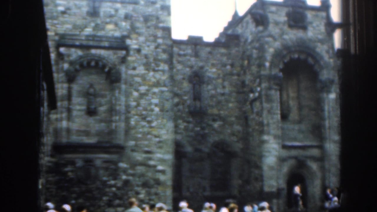 1961 London frame of a historic stone church entrance, with visitors near the doorway and soft 8mm color fading.