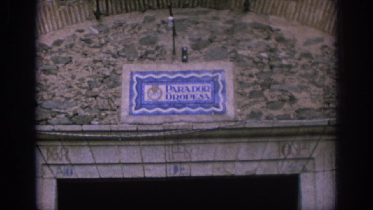 Ceramic Parador Oropesa sign above a stone arched entrance.