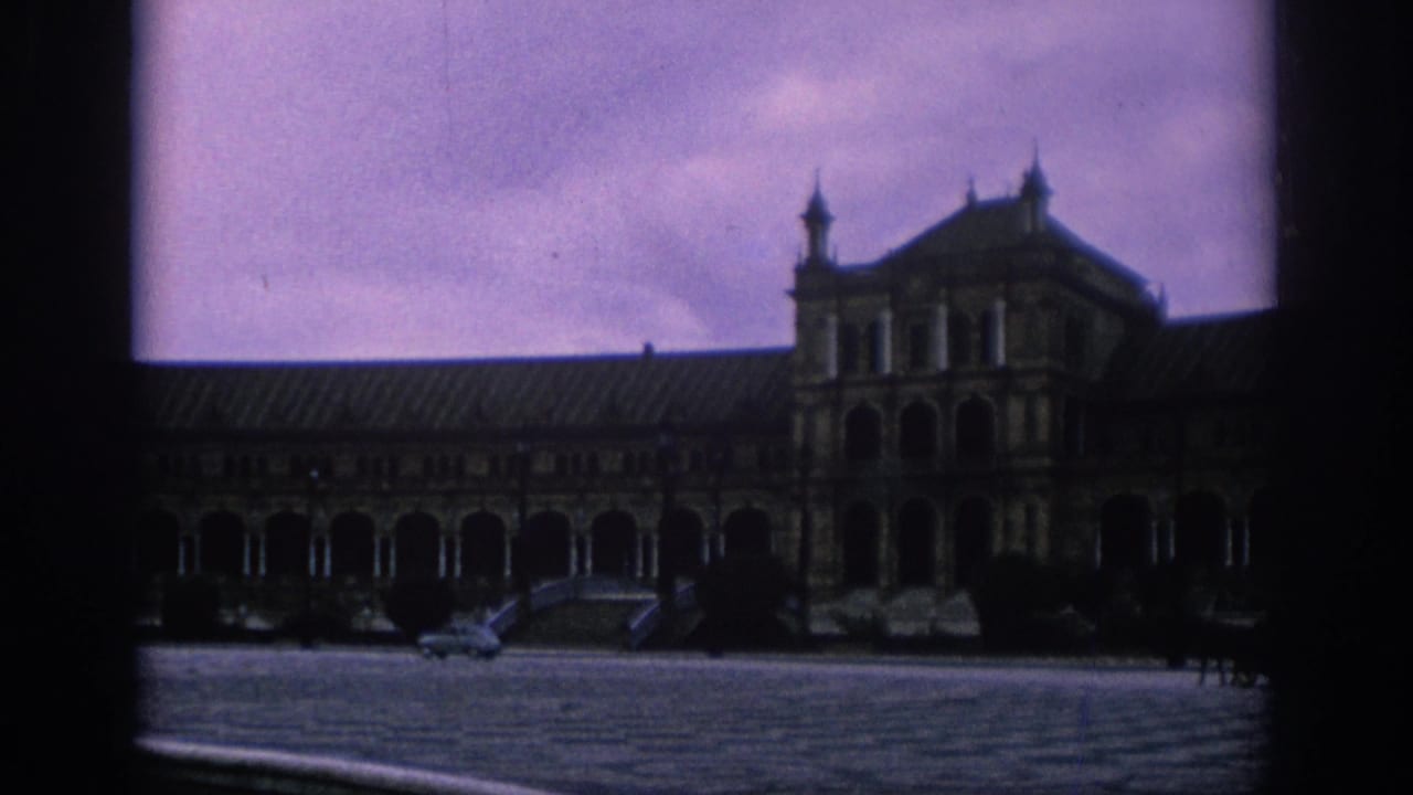 1966 Spain travel footage showing Plaza de Espana in Seville across a broad courtyard, with arched colonnades and soft 8mm color.