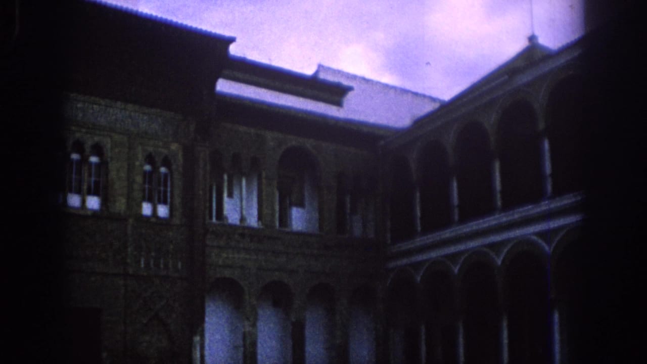 Courtyard corner with arcaded upper level, columns and patterned wall detail.