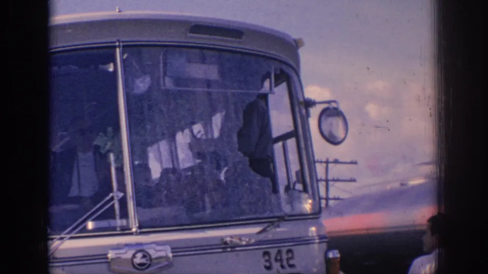 1966 Spain frame of a silver bus front with shattered windshield glass, front number 342, and a dark object near the window.