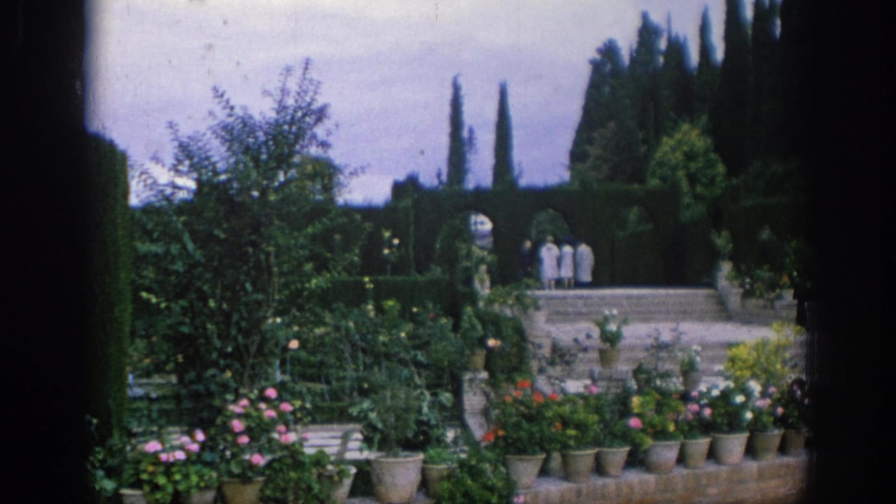 1966 Spain travel footage appears to show a formal garden with potted flowers, trimmed hedges, stone steps, and visitors in the distance.