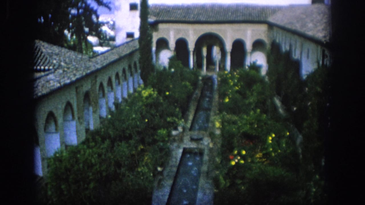 Historic courtyard with arched colonnades, tiled roof, greenery, and a narrow water channel.