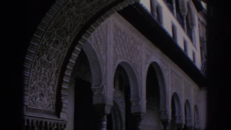 1966 Spain travel frame showing ornate Moorish-style arch carving, columns, and a shaded arched walkway.