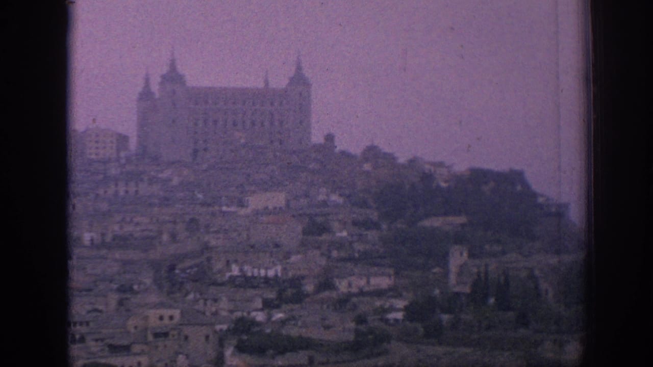 A similar 1966 Spain view holds on the hilltop structure identified in metadata as Toledo's Alcazar, with rooftops below and visible film grain.
