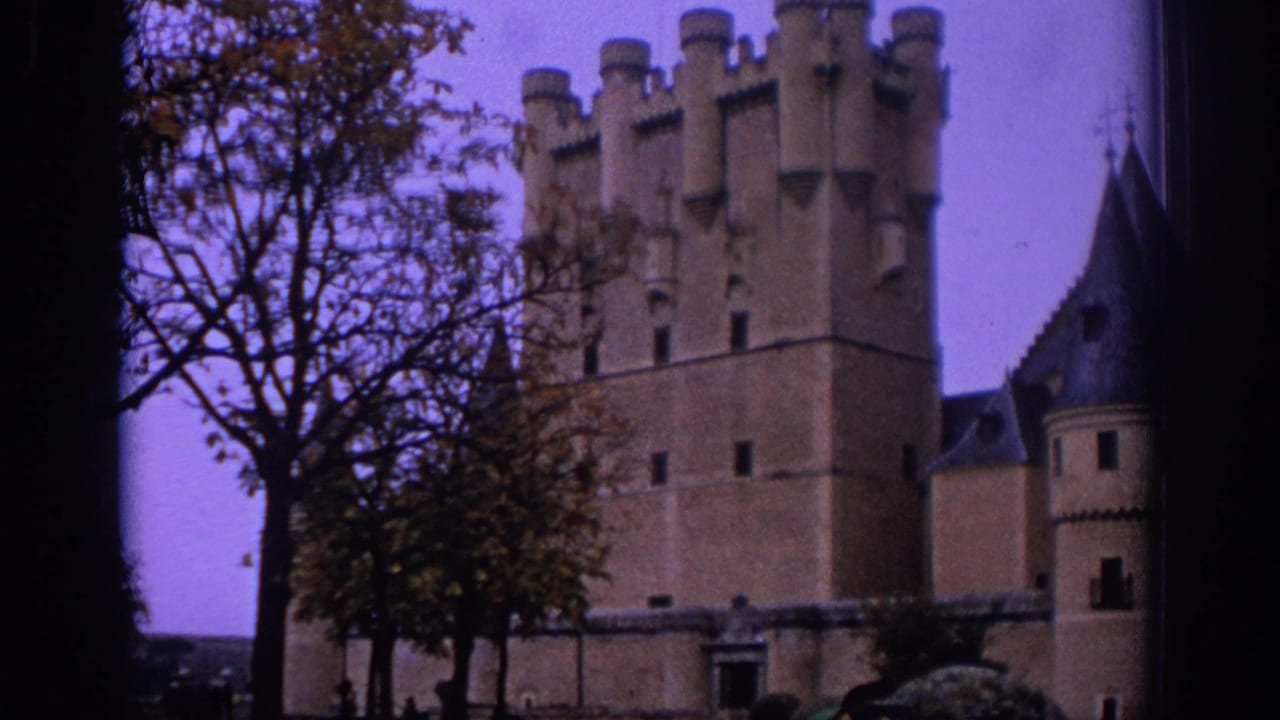 1966 Spain travel frame with a castle exterior, crenellated tower, side turret, trees, and courtyard approach.