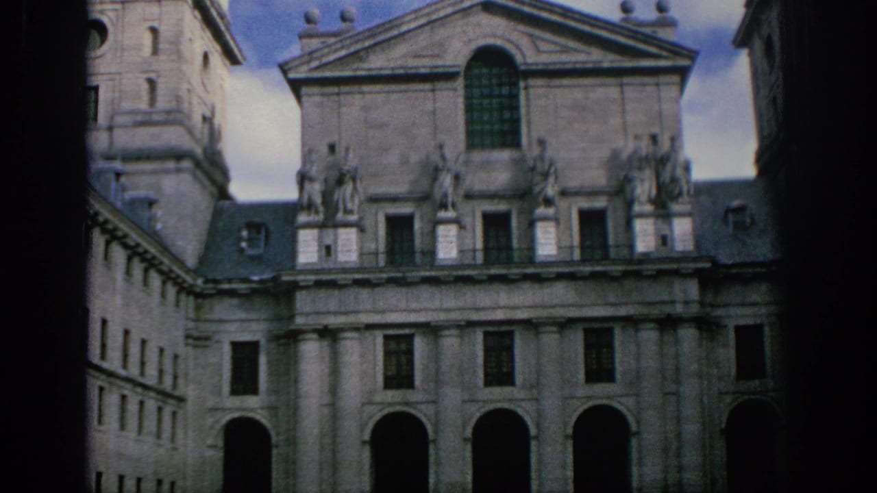 Stone facade with statues along the roofline and arched openings below.