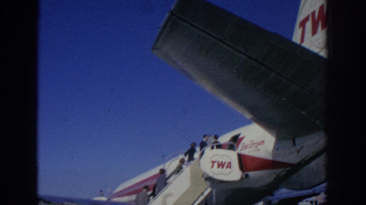 Passengers board a TWA StarStream aircraft by mobile stairs at a Spanish airport in 1966, with branding visible on the fuselage.