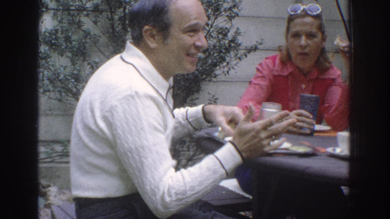 The man is seen in profile at the outdoor table, with the woman in a red shirt behind him holding near a cup in the 1971 Miami clip.