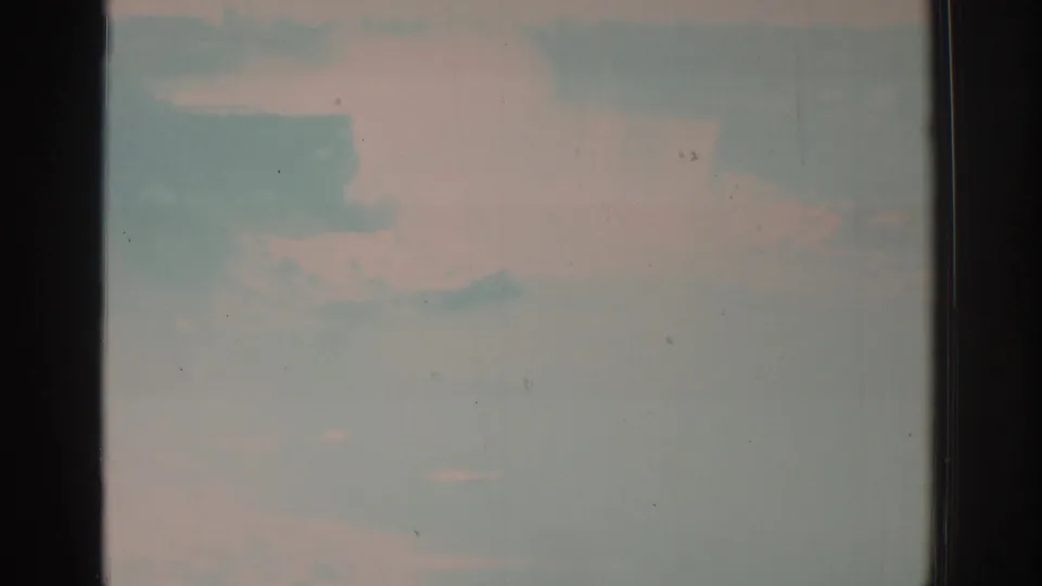 Opening 1971 8mm frame from Niagara Falls footage, with a washed pale sky or misty water area and visible film gate edges.