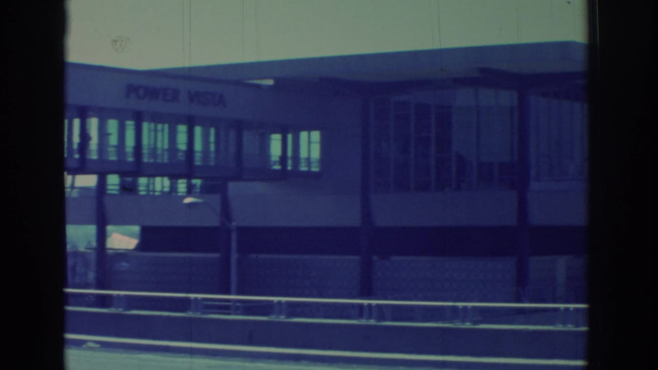 Glass-fronted POWER VISTA structure seen through dark vertical film borders.