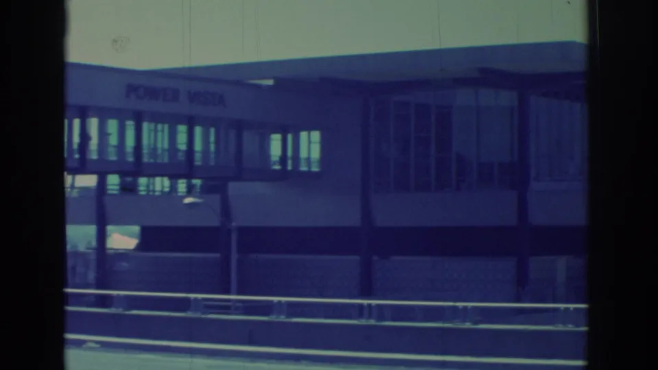 1971 Niagara Falls-area frame with POWER VISTA lettering on a modernist glass structure beside roadside railings.