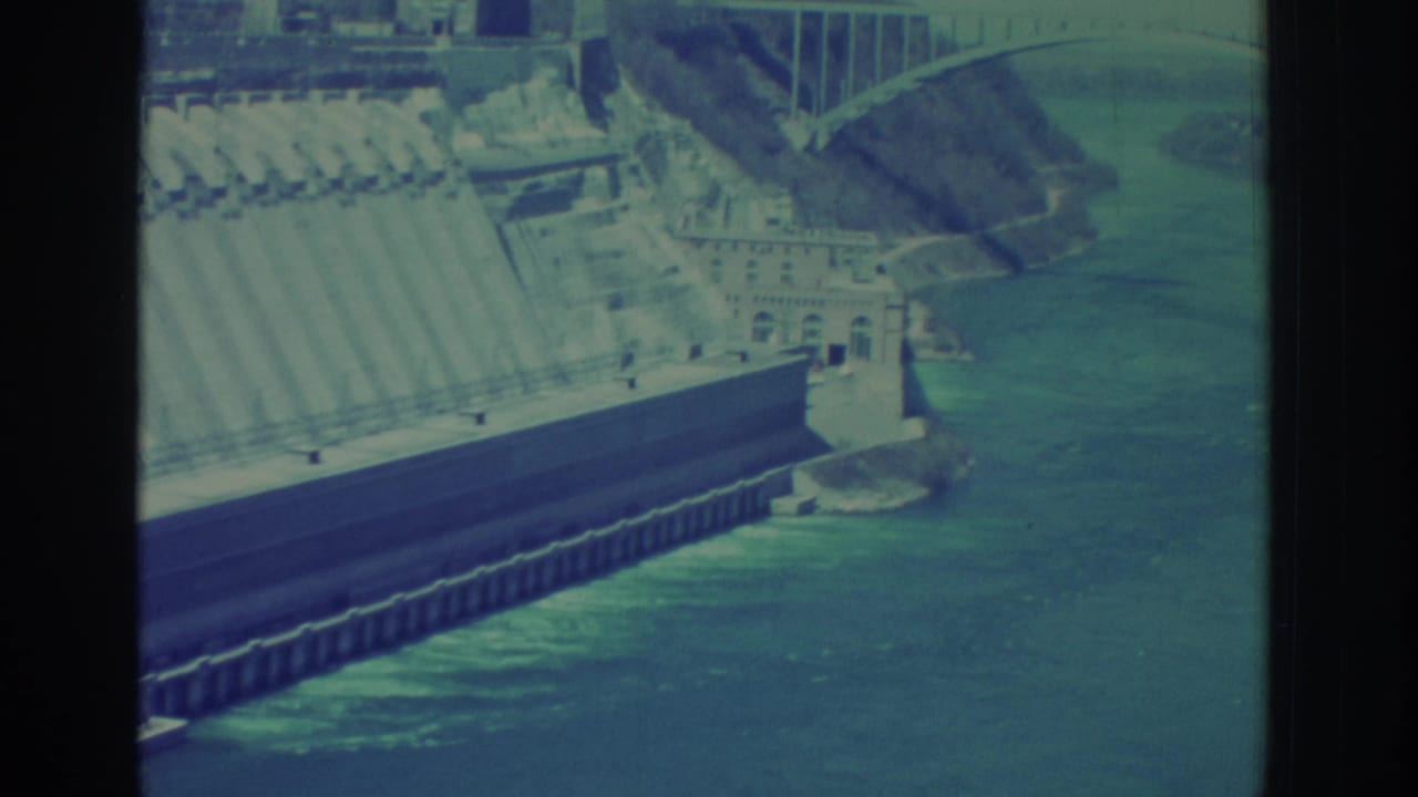 Niagara Falls area dam structure beside the river, filmed in 1971 with soft blue-green 8mm color.