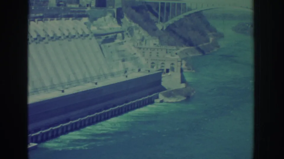 Niagara Falls area dam structure beside the river, filmed in 1971 with soft blue-green 8mm color.