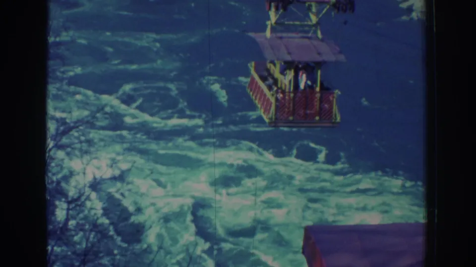 1971 Niagara Falls home-movie view of the cable car crossing over turbulent water, with passengers faintly visible.