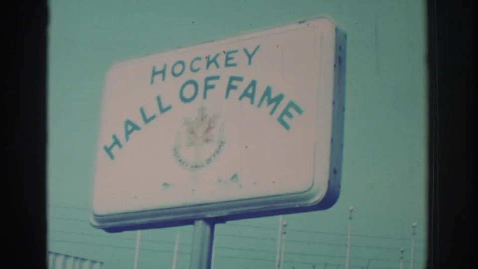 1971 Niagara Falls frame showing a roadside Hockey Hall of Fame sign with blue lettering and a maple leaf emblem.