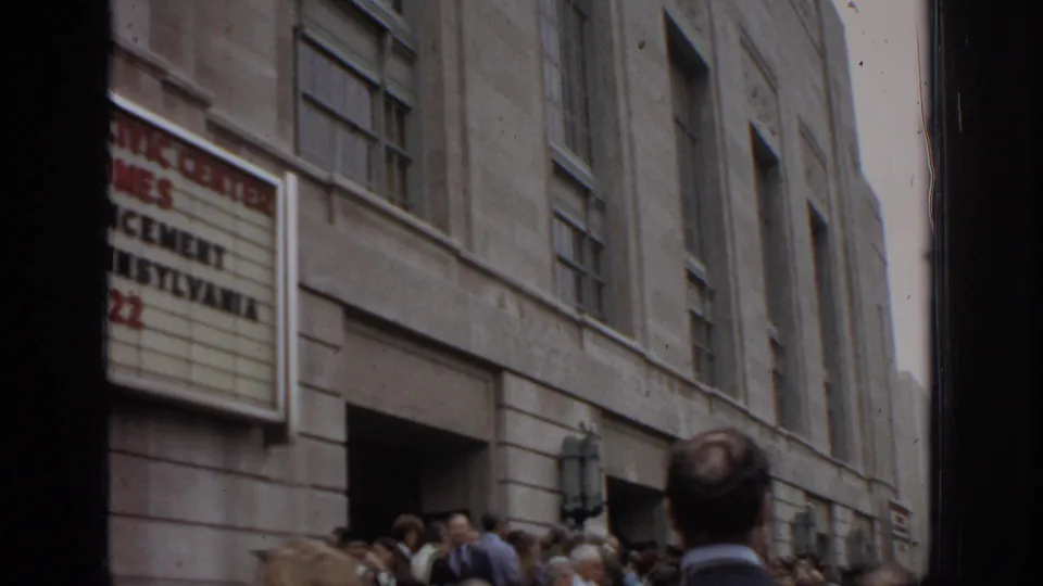 The Philadelphia Civic Center marquee appears above a commencement crowd gathered at the stone facade in 1972.