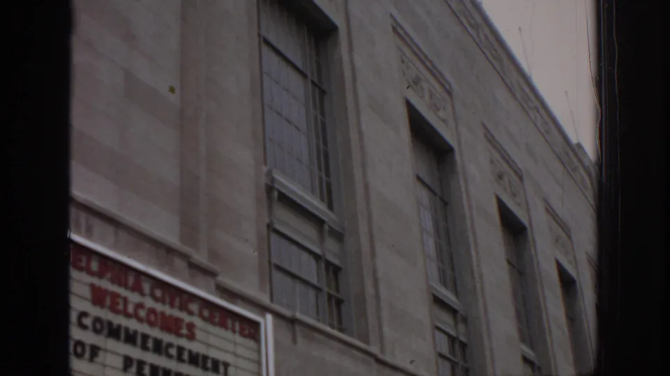 The civic-center facade fills the frame, with the 1972 commencement marquee partly visible near the lower edge.