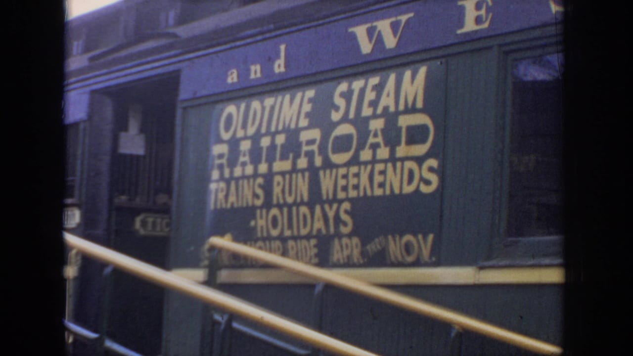Close view of a railcar sign advertising old time steam railroad trips.