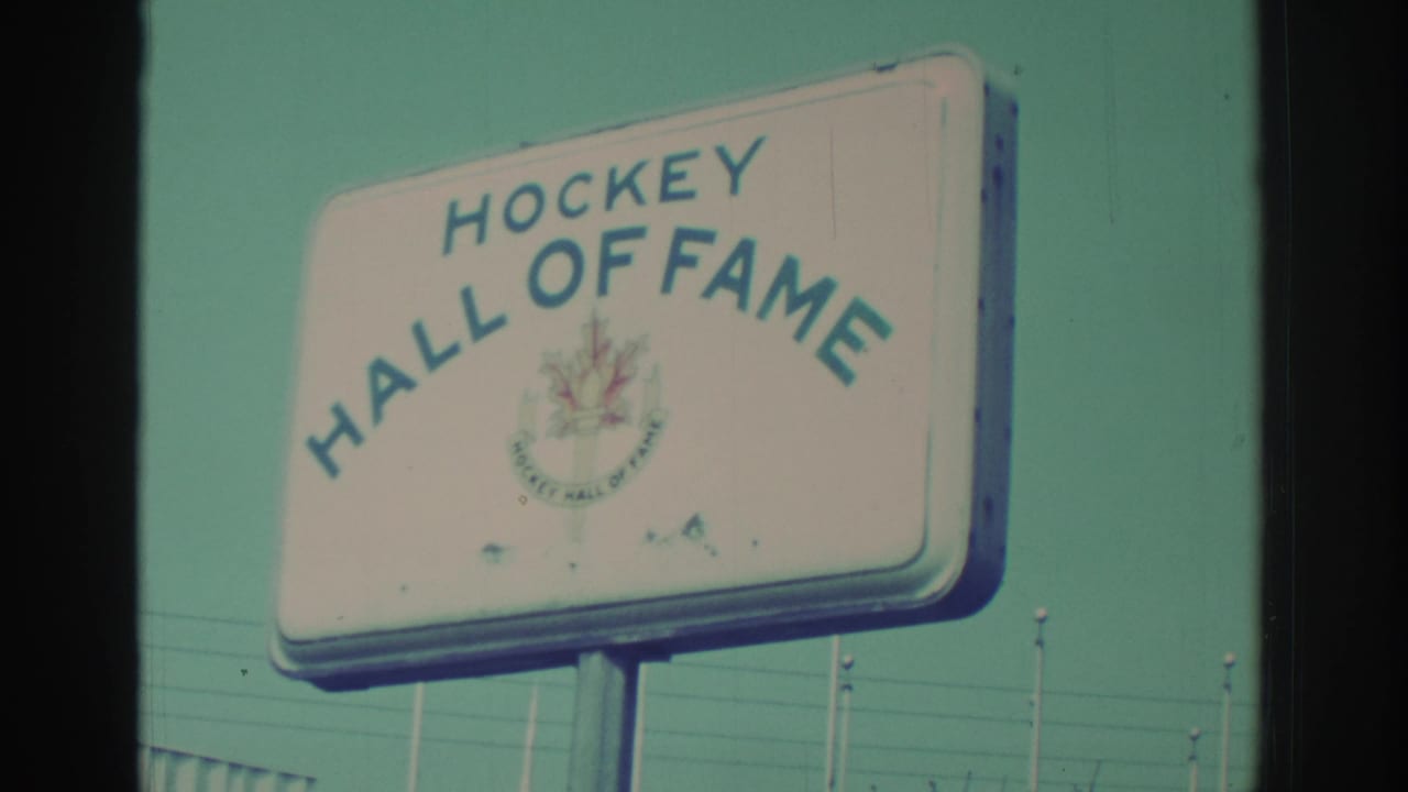 White Hockey Hall of Fame sign with blue lettering against the sky.