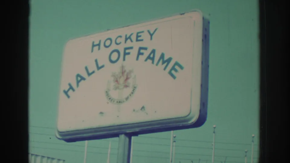 White Hockey Hall of Fame sign with blue lettering and a maple leaf emblem, filmed in Toronto in the 1970s.