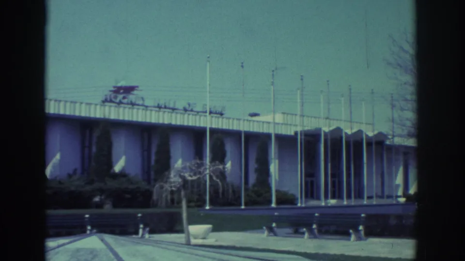 Toronto Hockey Hall of Fame exterior filmed in 1972, with a low facade, flagpoles, benches and landscaped foreground.