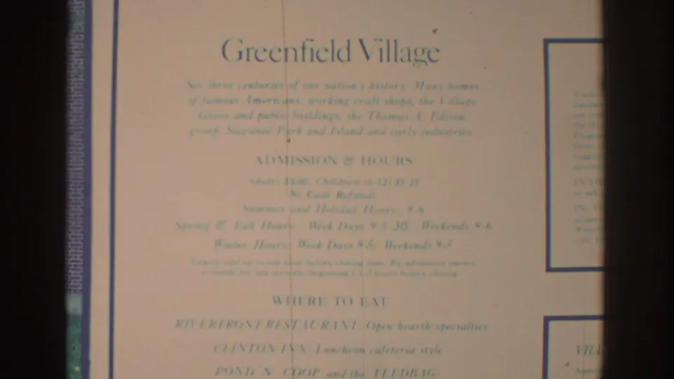 8mm frame showing a Greenfield Village information panel with admission text, partially obscured by dark film-frame edges.