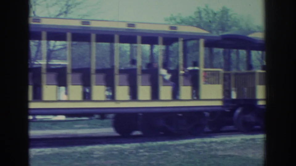 1972 Toronto frame showing the side of the yellow sightseeing car, with passengers visible as the train continues past.