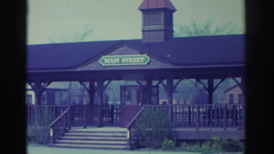 1972 Toronto frame of a wooden Main Street station frontage with stairs, railings, roofline, and small cupola.