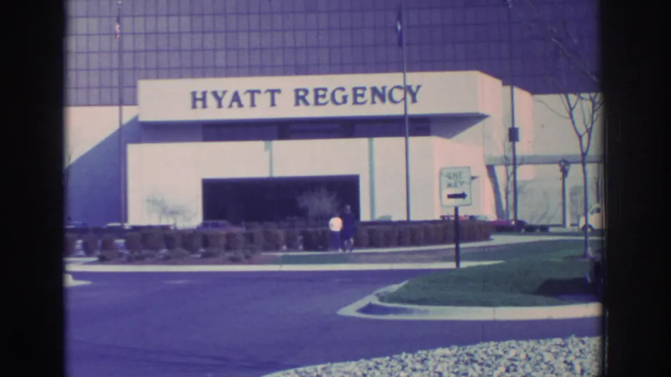 1972 Toronto Hyatt Regency exterior showing the entrance sign, curved drive, landscaping, and two small figures by the doorway.