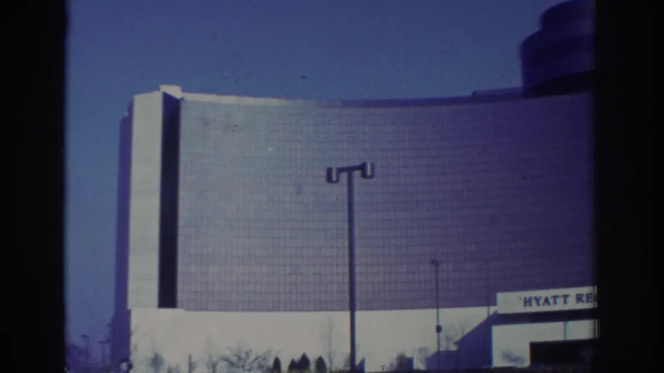 1972 Toronto view of the Hyatt Regency exterior, showing the curved glass wall, signage, streetlight, and clear sky.