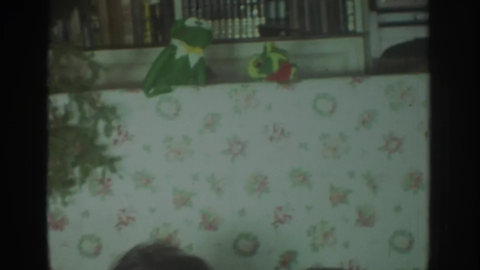 1972 Toronto home-movie view of the puppet stage with a partial viewer's head entering the lower frame.