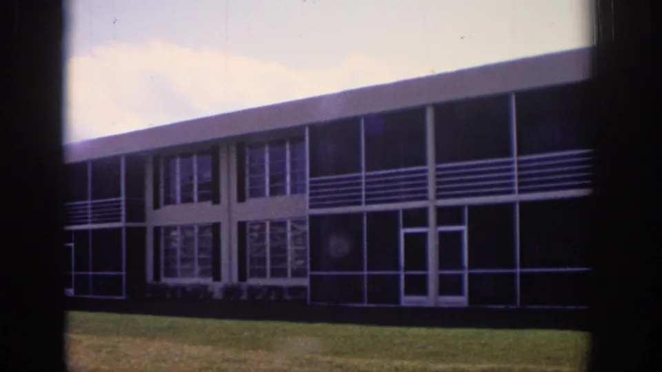 1973 Naples, Florida 8mm view of a glass-and-rail modernist exterior during a slow pan.
