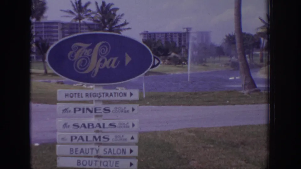 1973 Naples, Florida resort frame showing The Spa directional sign with arrows for registration, golf courses, salon, and boutique.
