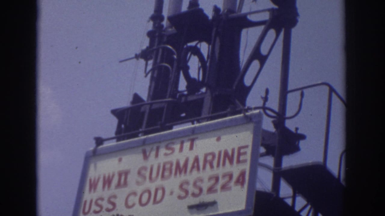 USS Cod visitor sign and submarine tower details seen from below.