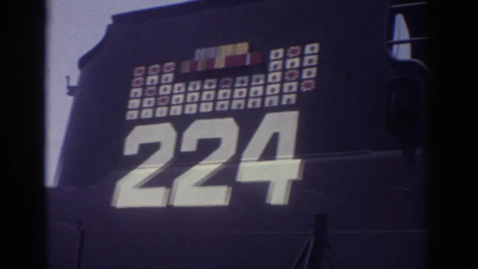 1974 Cleveland home-movie frame showing the USS Cod hull number 224 below the visitor sign and campaign-style marking grid.