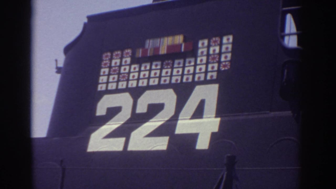 1974 Cleveland 8mm frame showing a close view of a preserved military submarine hull marked 224 with rows of painted insignia above.